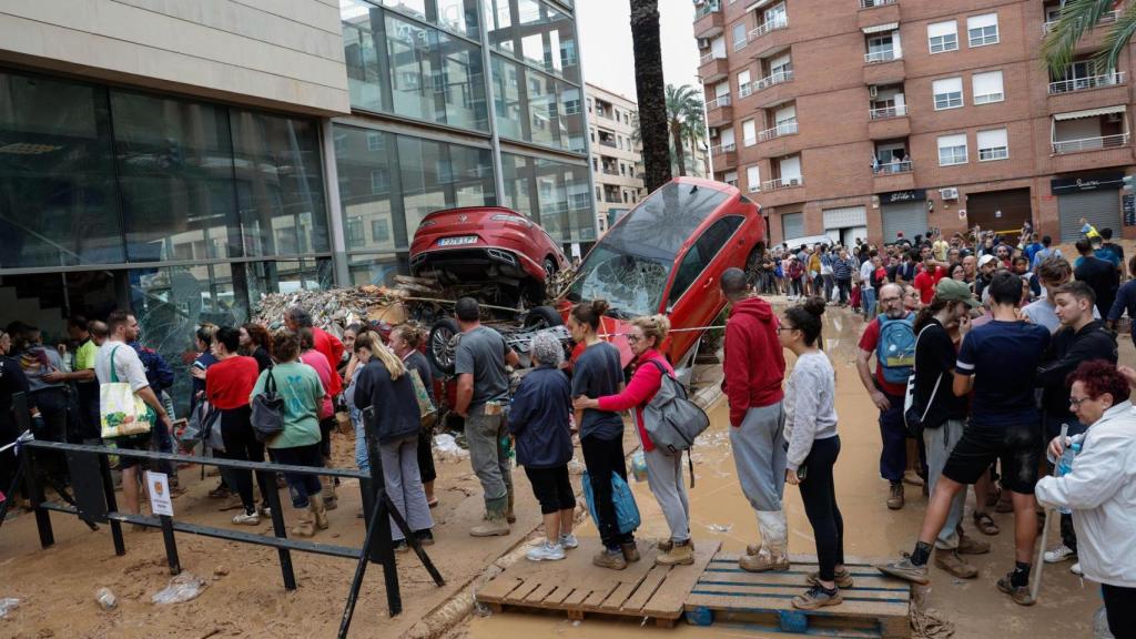 Varias personas esperan para recibir ayuda este jueves en Paiporta.